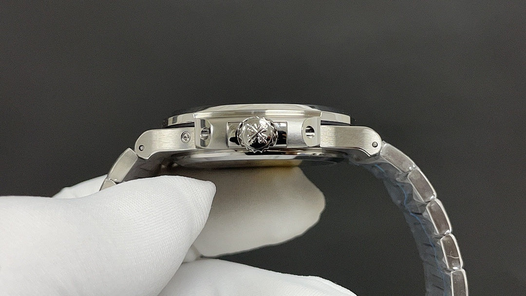Patek Philippe watch clasp and case top with polished silver finish.