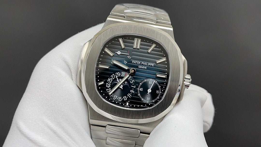 Patek Philippe watch with dark blue dial and silver bezel, visible subdials.