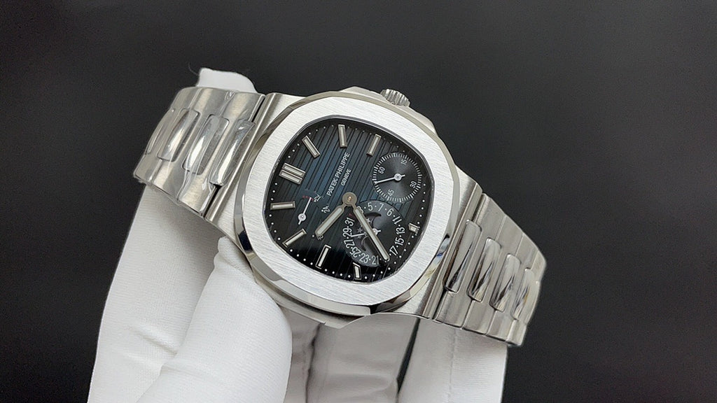 Patek Philippe watch angled view with silver bracelet, dark blue dial, subdials.