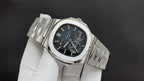 Patek Philippe watch angled view with silver bracelet, dark blue dial, subdials.