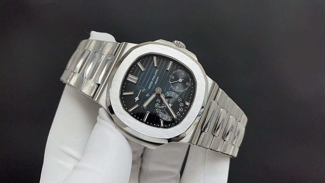 Patek Philippe watch angled view with silver bracelet, dark blue dial, subdials.