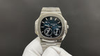 Patek Philippe watch front view with silver bracelet and dark blue dial, subdials.
