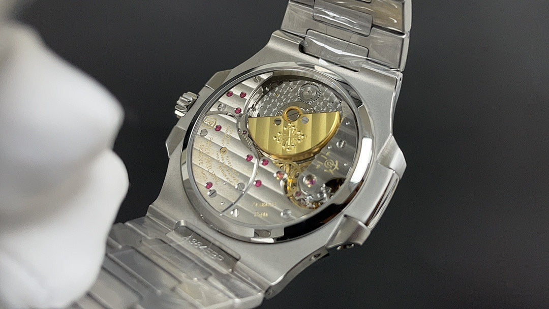Stainless steel watch with exposed movement, gold-toned balance wheel in glass
