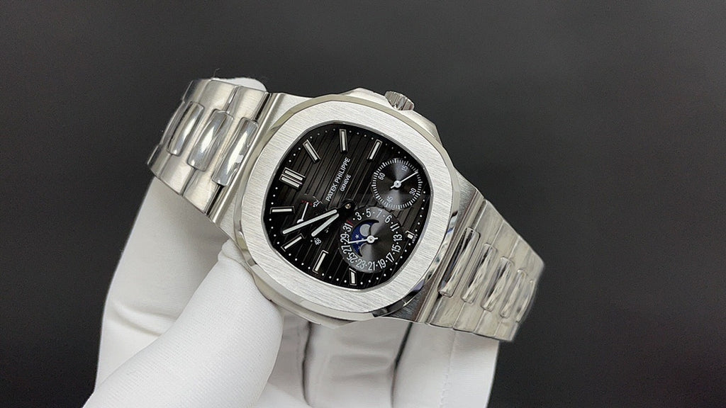 Stainless steel chronograph watch with black dial and metal bracelet links, angled view
