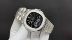 Stainless steel chronograph watch with black dial and metal bracelet links, angled view