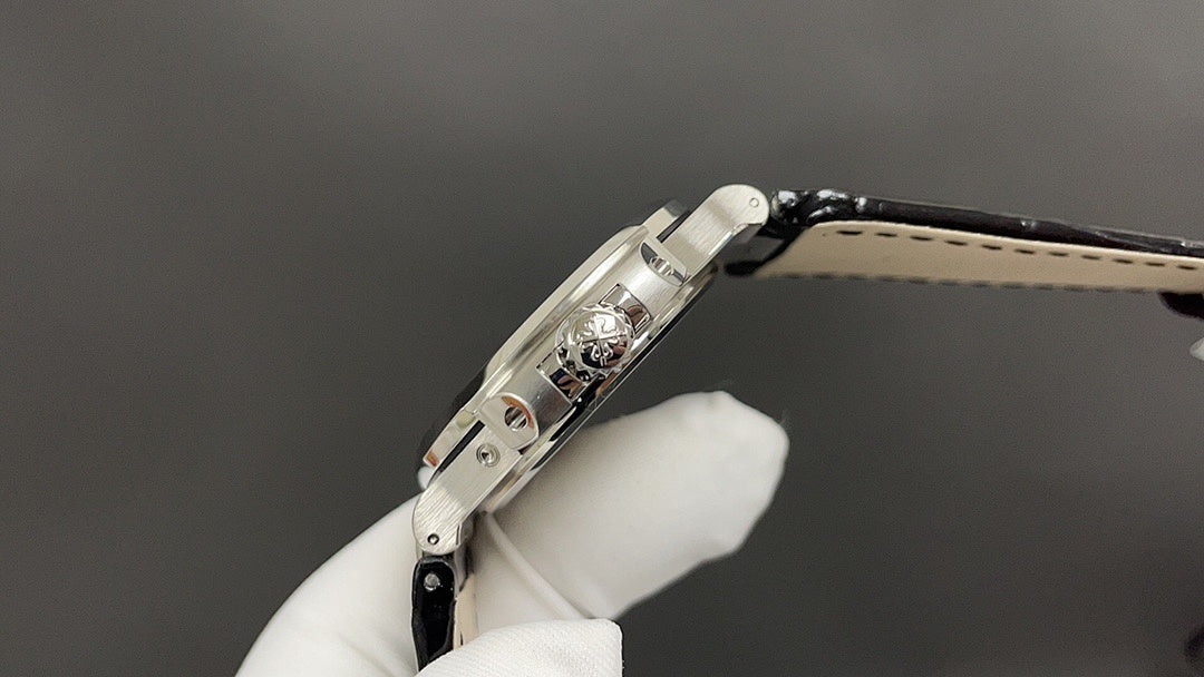 Patek Philippe watch, angled back view with crown, steel case and black leather strap