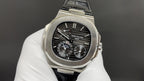 Patek Philippe watch, front view with black dial, steel case and black leather strap