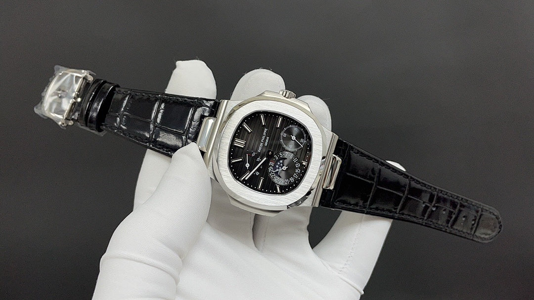 Patek Philippe watch on wrist, black dial with subdials and black leather strap