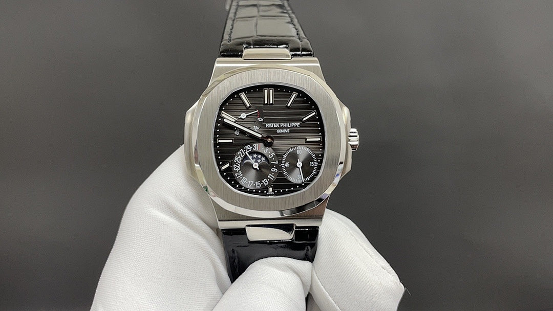 Patek Philippe watch close-up, black dial, steel case and black leather strap