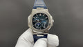 Patek Philippe watch, stainless steel case, black dial, blue leather strap.