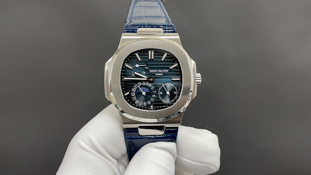 Patek Philippe watch, stainless steel case, black dial, blue leather strap.