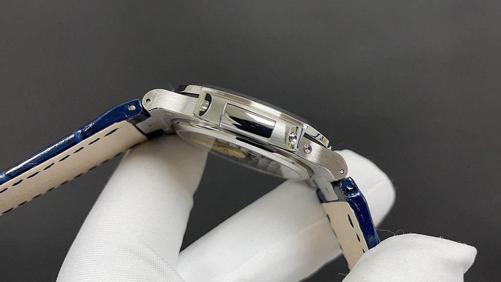Patek Philippe watch side view, stainless steel case with blue leather strap.