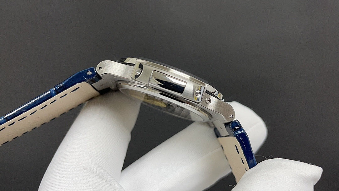 Patek Philippe watch side view, stainless steel case with blue leather strap.