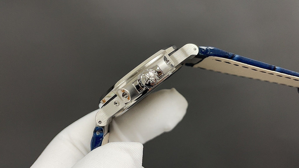 Patek Philippe watch crown side, stainless steel case and blue leather strap.