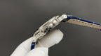 Patek Philippe watch crown side, stainless steel case and blue leather strap.