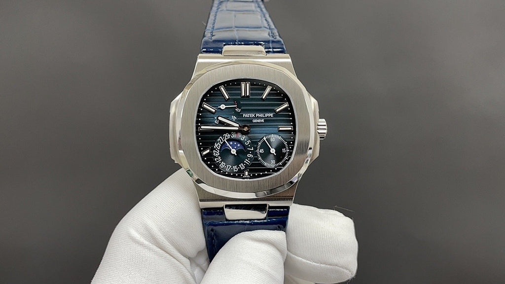 Patek Philippe watch, front display with black dial and blue leather strap.