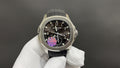 Patek Philippe wristwatch with black dial, purple details, and black rubber strap