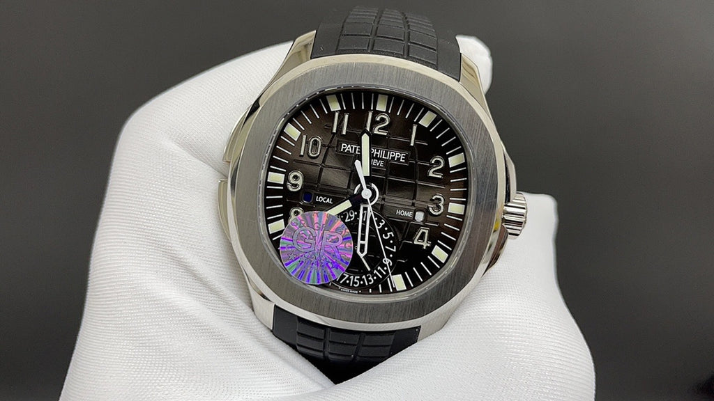 Patek Philippe wristwatch with black dial, purple motif, and black rubber strap