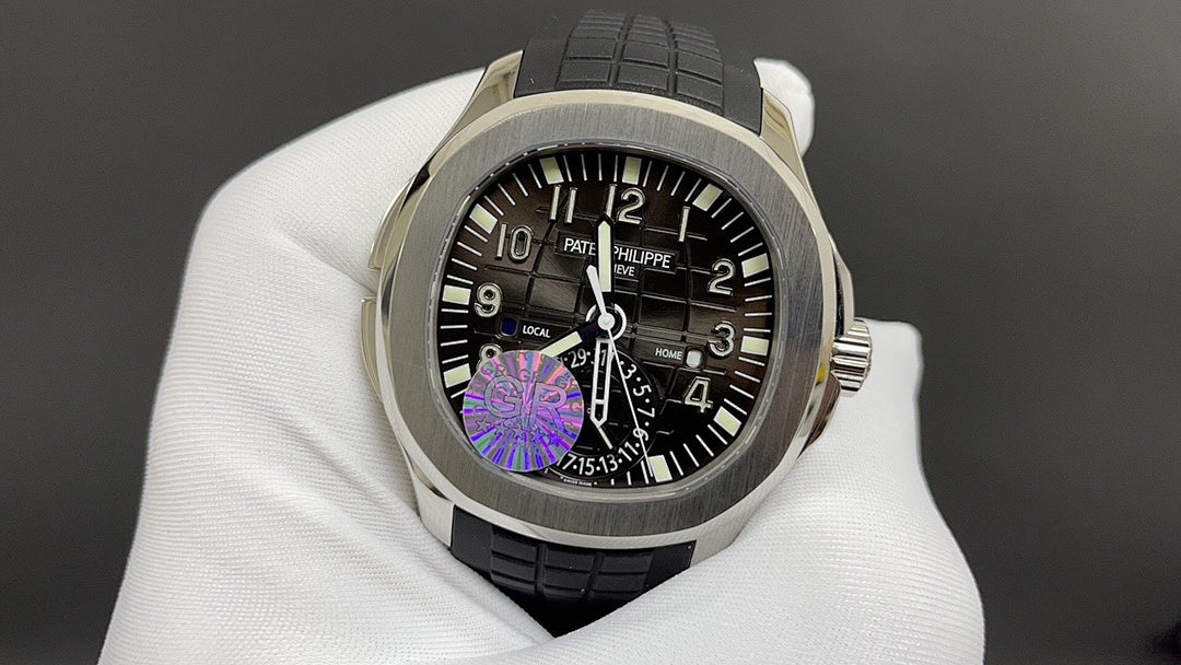 Patek Philippe wristwatch with black dial, purple motif, and black rubber strap