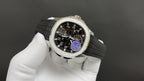 Patek Philippe wristwatch side view with black dial and purple gear detail