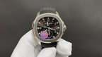 Patek Philippe wristwatch front view with black dial, purple details, black rubber strap