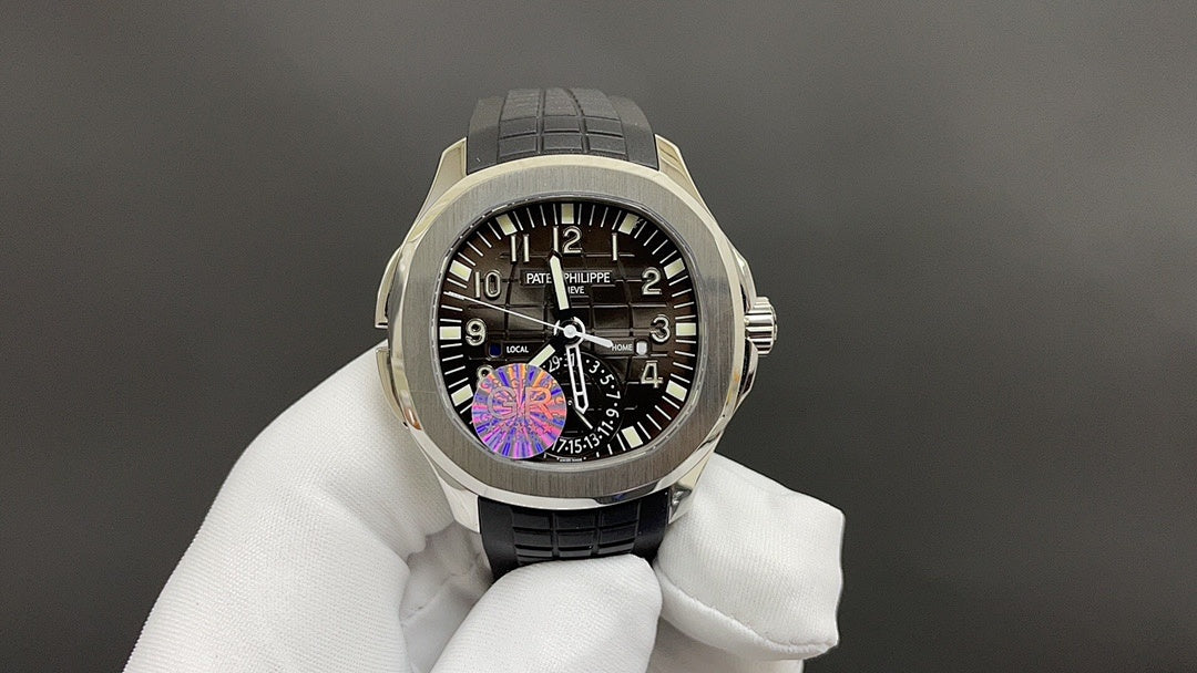 Patek Philippe wristwatch front view with black dial, purple details, black rubber strap