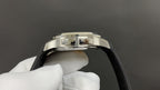 Patek Philippe watch with silver case and black strap, side profile