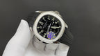Patek Philippe watch with black dial, rainbow reflection, steel case, gray strap