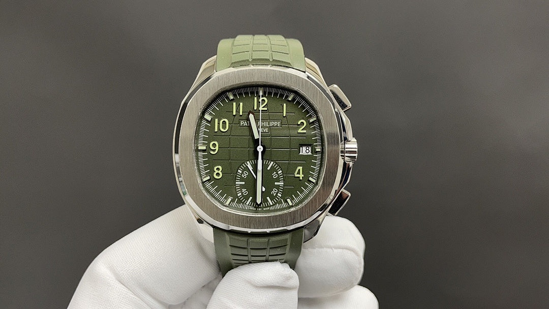 Round wristwatch with green dial, silver-tone case, and green rubber strap on white gloves