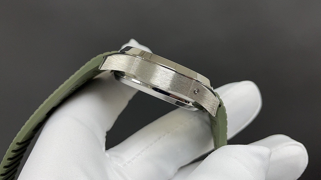 Wristwatch side profile with silver-tone case and green rubber strap held by white gloves