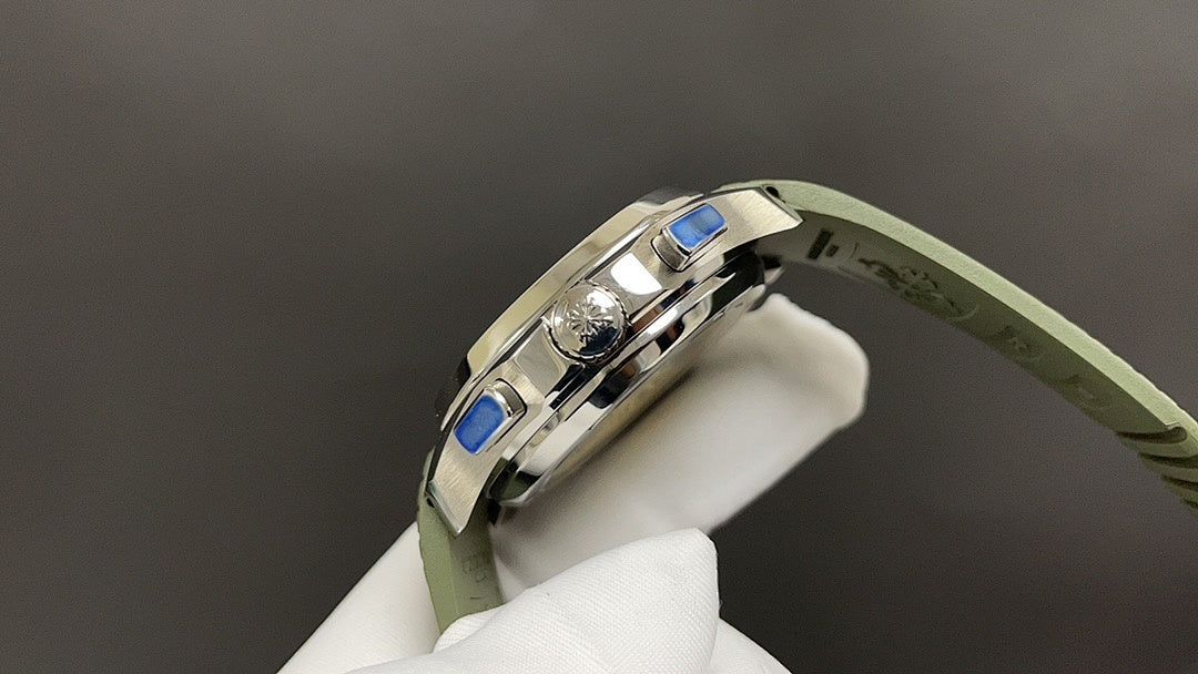 Wristwatch side view with blue accents on bezel, green rubber strap, silver-tone case