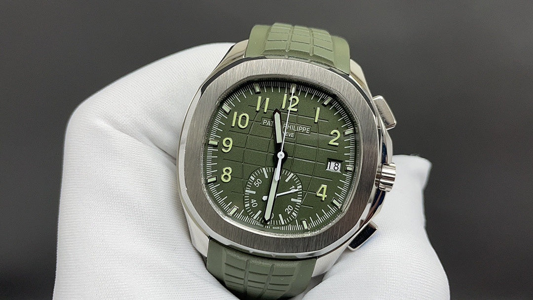 Round wristwatch with green dial and green rubber strap, silver-tone case on white gloves