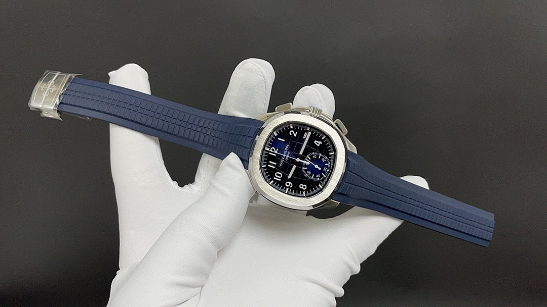Patek Philippe wristwatch on blue strap held by gloves, dial visible