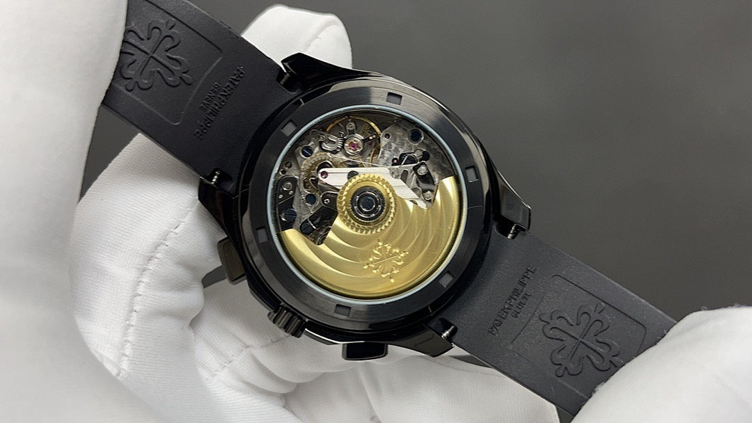 Patek Philippe watch movement view with black case and exposed gold-toned balance