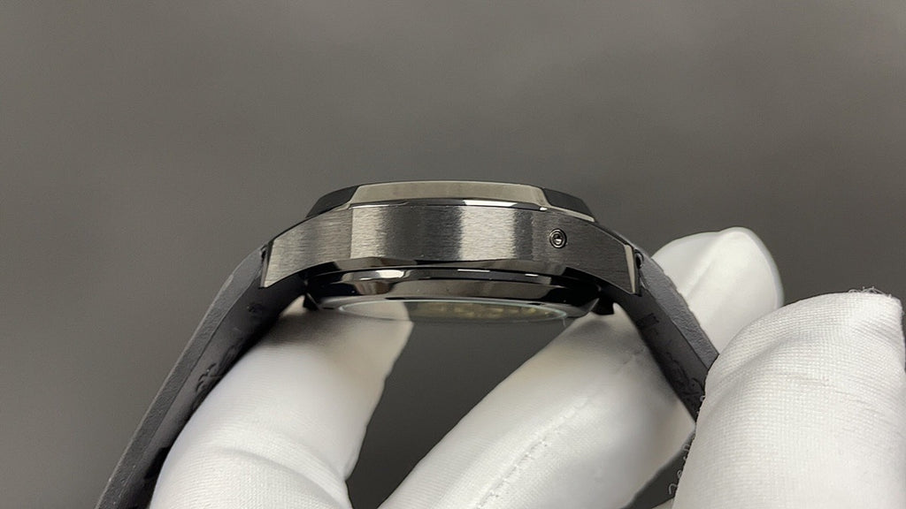 Patek Philippe watch caseback with brushed metal bezel and black strap