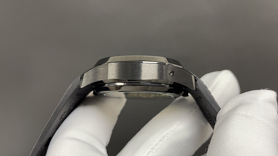 Patek Philippe watch caseback with brushed metal bezel and black strap