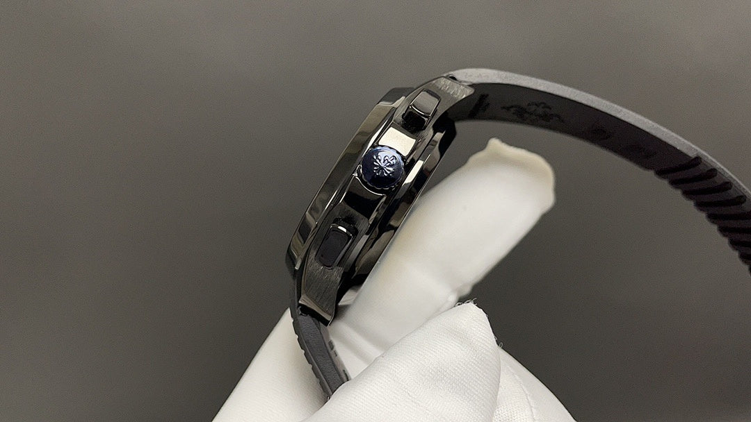 Patek Philippe watch crown side with brushed metal case and black rubber strap