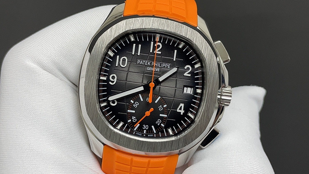 Patek Philippe wristwatch with orange rubber strap and black dial, chronograph subdials.