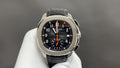 Patek Philippe watch with black dial, orange accents, stainless case, black leather strap