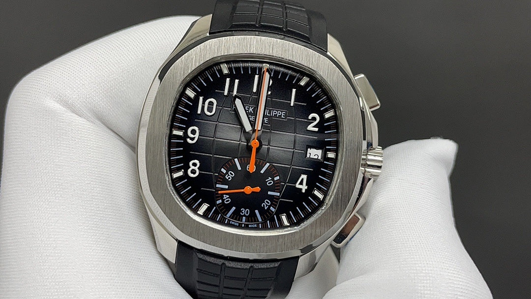 Patek Philippe watch with black dial, orange chronograph hands, black strap, steel case