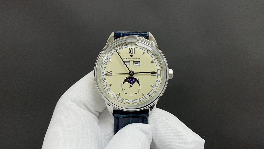 Patek Philippe wristwatch with white dial, blue leather strap, Roman numerals.