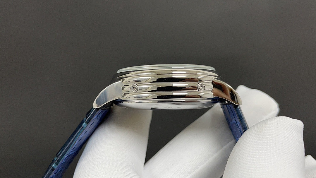 Patek Philippe wristwatch side profile with blue leather strap and polished metal case.