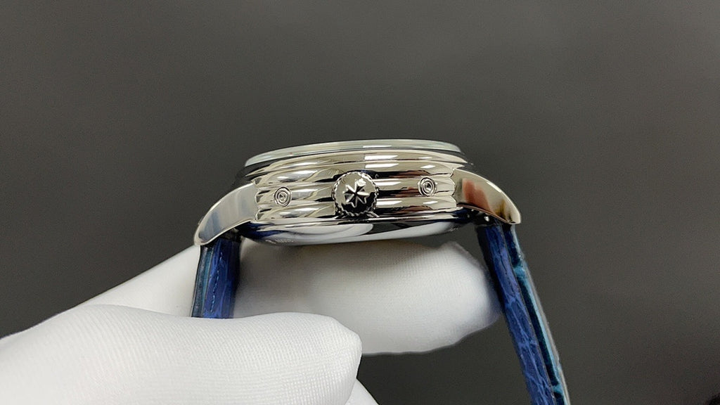 Patek Philippe wristwatch side view with crown detail, blue leather strap, polished case.