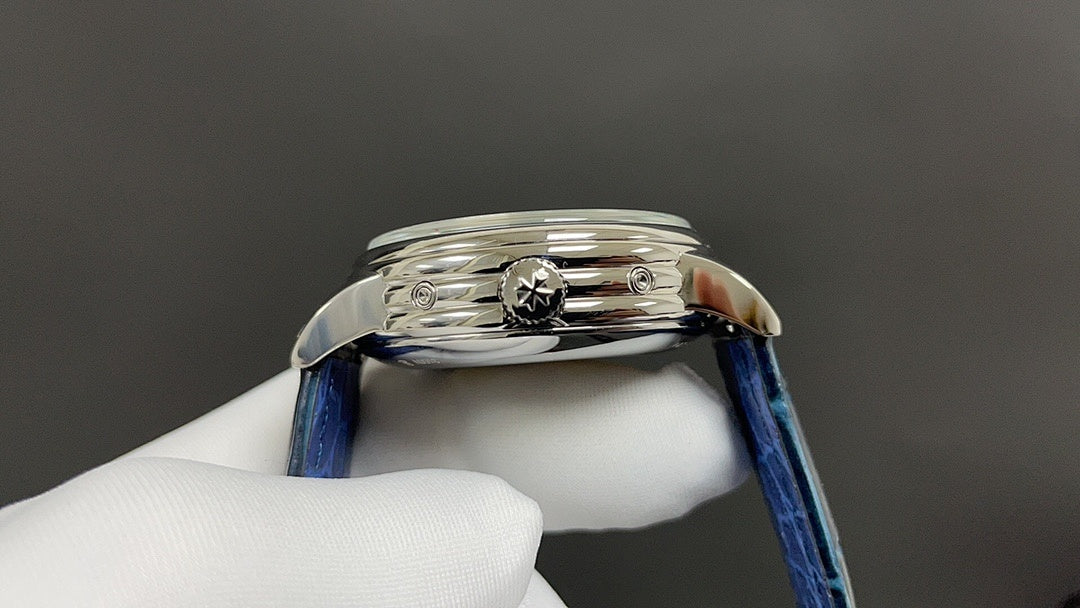 Patek Philippe wristwatch side view with crown detail, blue leather strap, polished case.