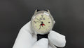Stainless steel wristwatch with cream dial, Roman numerals, black leather strap, crown at 3