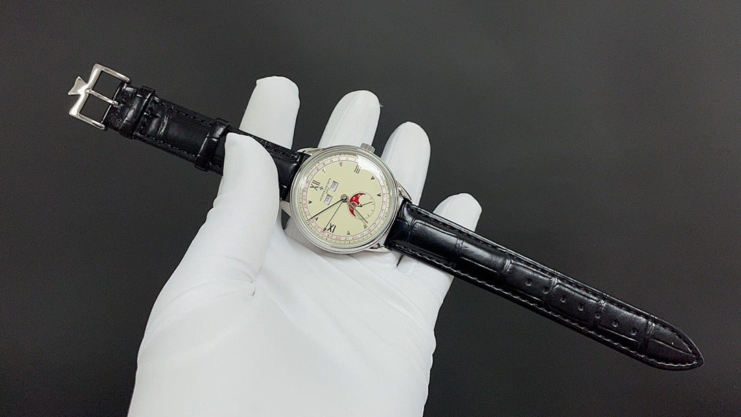 Wristwatch with black leather band extended across gloves; cream dial with Roman numerals