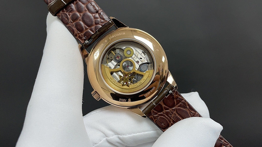 Luxury wristwatch back with gold-tone case and brown leather strap, openwork movement