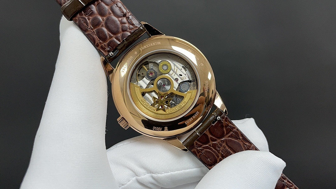 Luxury wristwatch back with gold-tone case and brown leather strap, openwork movement