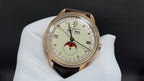 Luxury wristwatch with gold-tone case, white dial and brown leather strap