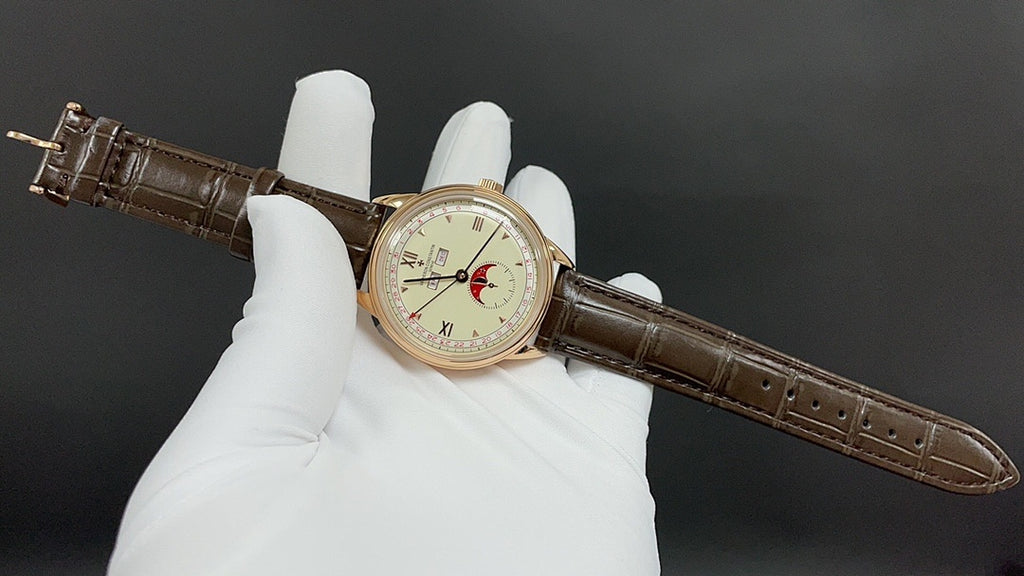 Luxury wristwatch on brown leather strap with round white dial and gold-tone case